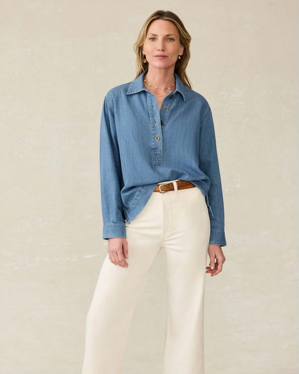 Front view of model wearing Faherty Oceanview linen denim top in coastal cloud wash styled with white denim. Model stands against plain backdrop. 