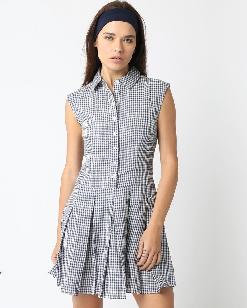 Woman wearing a sleeveless checkered dress on a white background