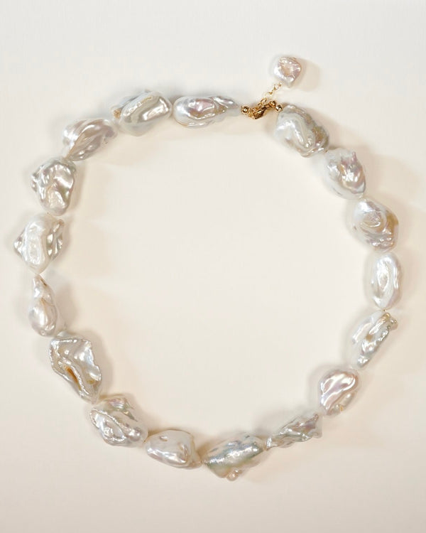 Large baroque pearls on plain background