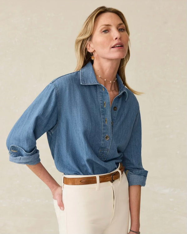 Front view of model wearing Faherty Oceanview linen denim top in coastal cloud wash styled with white denim. Model stands against plain backdrop. 