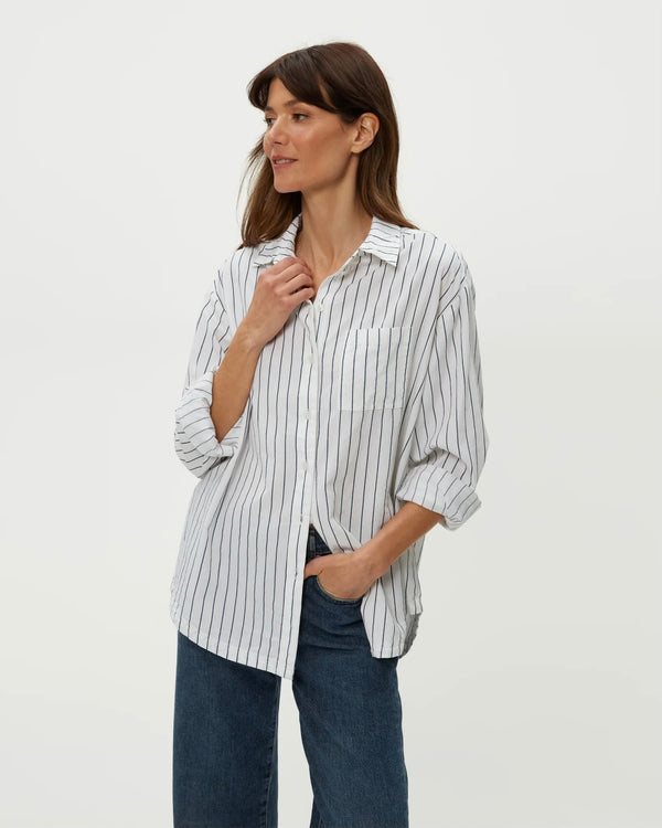 Model wearing navy striped Michael Stars Beau Oversized Button Down styled with jeans, standing against plain backdrop.