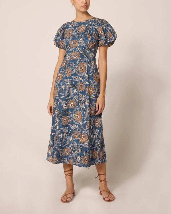 Front view of model wearing Cleobella Leslie midi dress in magnolia floral print against a plain backdrop.