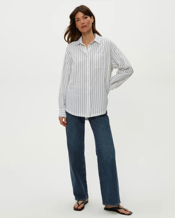 Model wearing navy striped Michael Stars Beau Oversized Button Down styled with jeans, standing against plain backdrop.