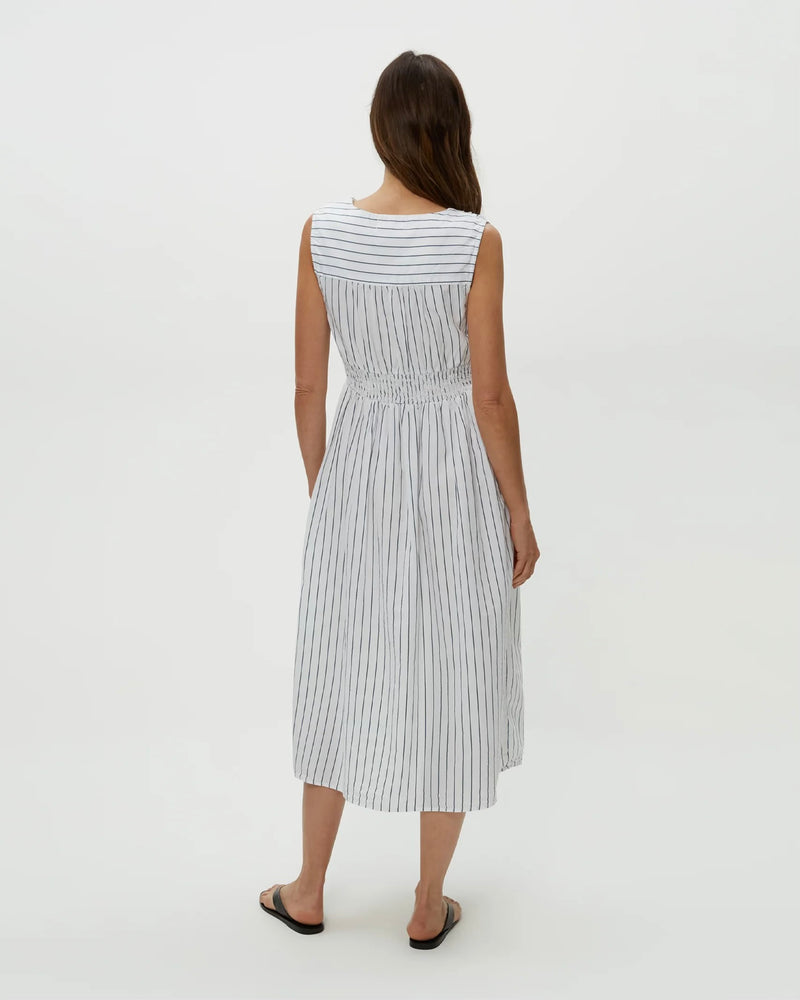 Back view of model wearing navy stripe Michael Stars Penelope Twist Front Midi against plain backdrop